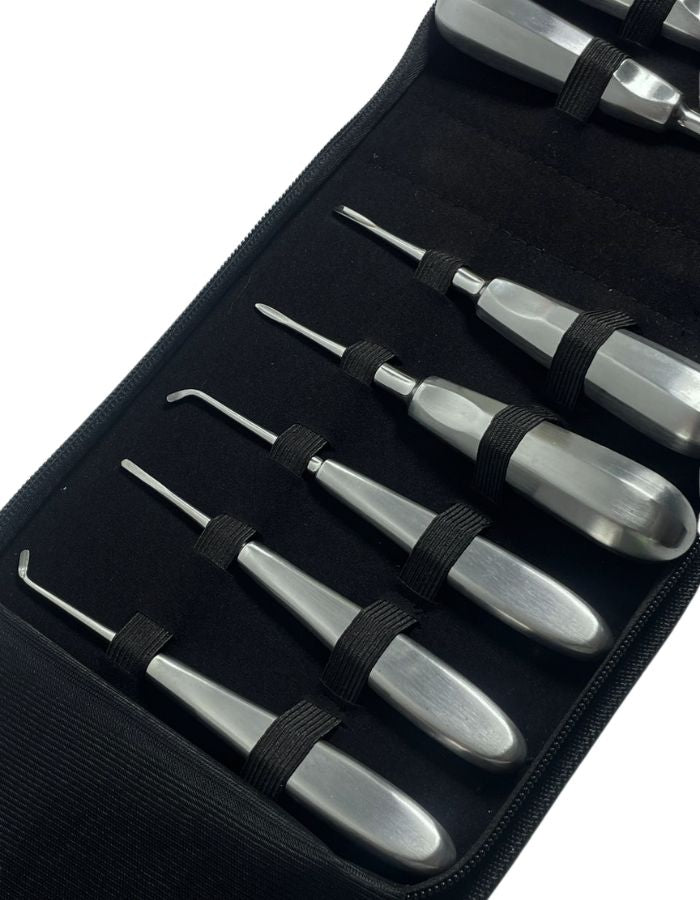 Set of metal tools in a black case on a white background